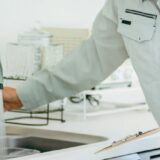 キッチンの水道をチェックする作業員